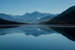 Snow-capped mountains reflected in a calm alpine lake mountain lake foogallery sample image 1