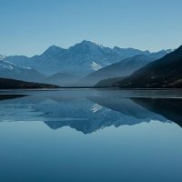 Snow-capped mountains reflected in a calm alpine lake mountain lake foogallery sample image 1